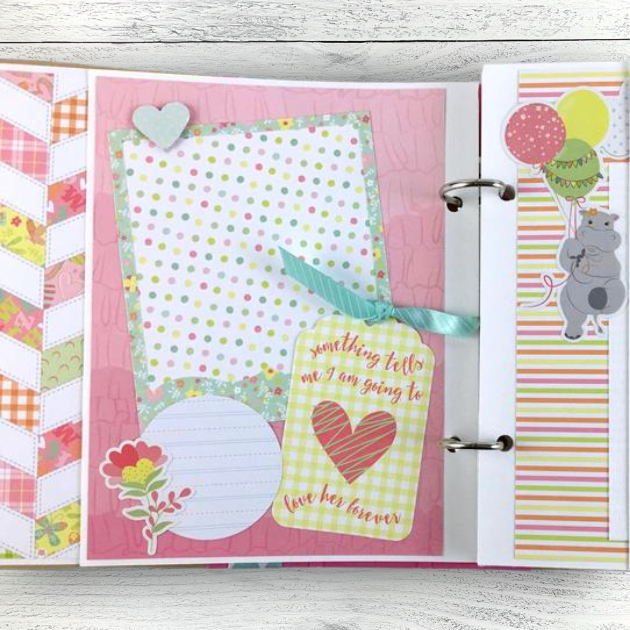 Baby Girl Scrapbook Album Page with a flower, heart, polka dots, and a hippo with balloons