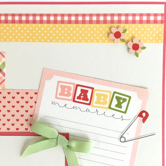 12x12 It's A Girl Baby Scrapbook Page Layout with flowers, hearts, polka dots, a cute green bow, and a journaling card with baby blocks
