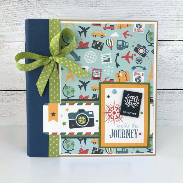 Enjoy The Journey Travel Scrapbook Mini Album with a passport, globes, airplanes, cameras, cars, ships, and luggage