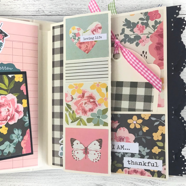 I AM Scrapbook Mini Album page with flowers, a butterfly, a pocket, a tag with ribbon, and a scalloped lace trim