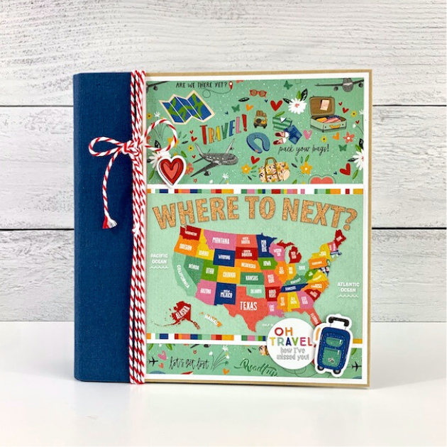 Where To Next Travel Scrapbook Album with a map, vibrant colors, and travel accessories