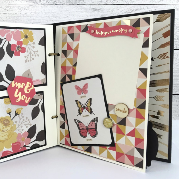 My Story Scrapbook Album Page with pretty butterflies, a geometric triangle print, and enamel brads
