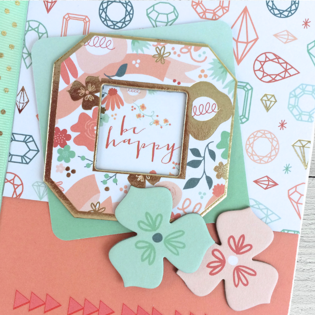 Be Happy Scrapbook Mini Album with jewels, flowers, a ribbon, and a little frame with gold foil accents
