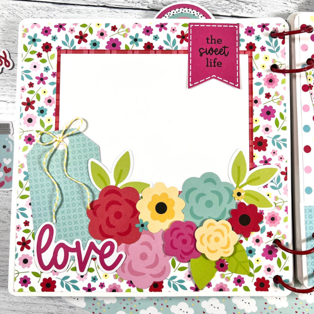 Valentine's Day Lots of Love scrapbook album page with flowers, tags, and a twine bow