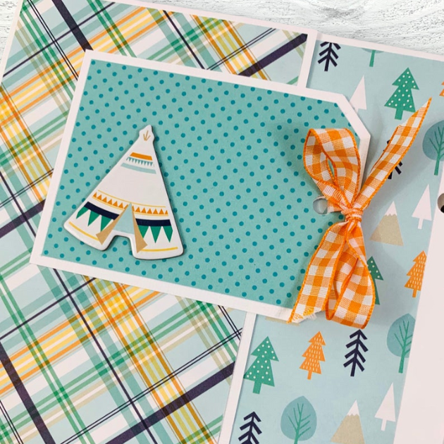 Hello Baby Boy Scrapbook Mini Album Page with a cute tepee, trees, a polka dot tag with orange gingham ribbon, and a fabulous plaid paper