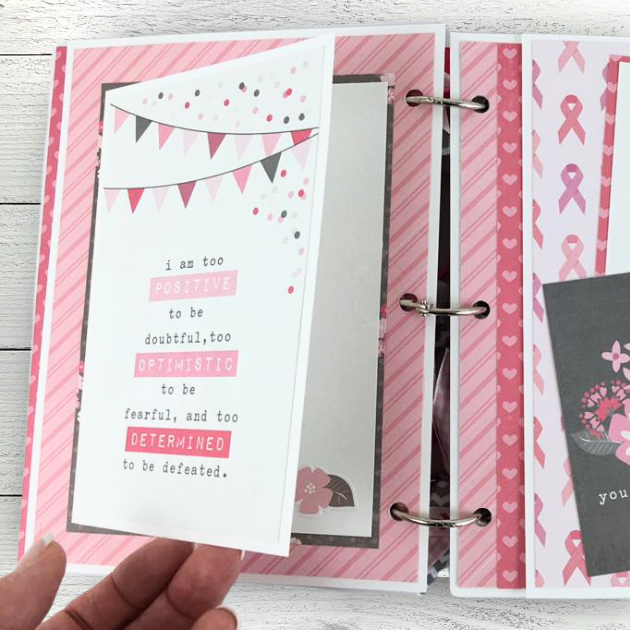 Breast cancer themed scrapbook mini album page with a folding element, hearts, a banner, and pink ribbons