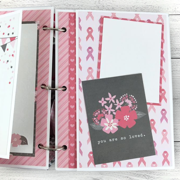 Breast cancer themed scrapbook mini album page with pink ribbons, hearts, stripes, and pretty flowers