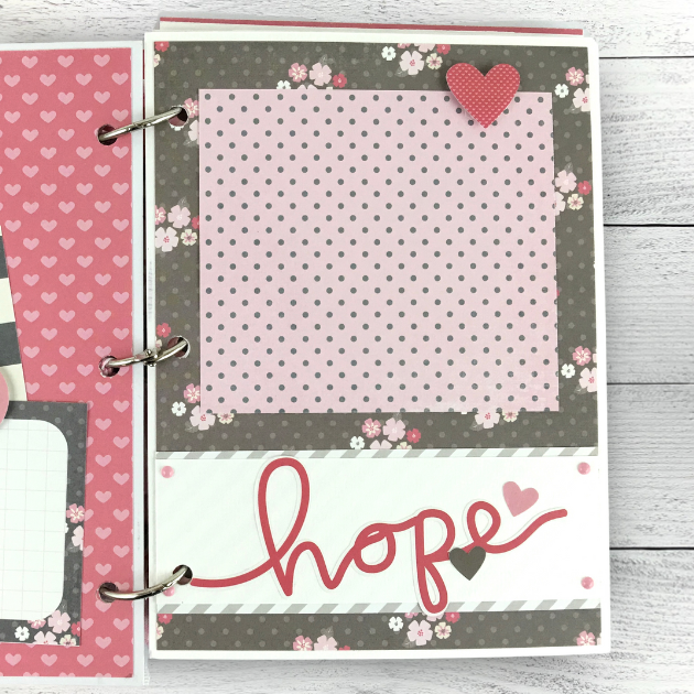Breast cancer themed scrapbook mini album page with pink hearts, flowers, and polka dots