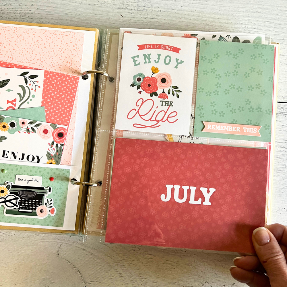 A Year in Review Scrapbook Album Page with flowers, journaling space, and a pocket