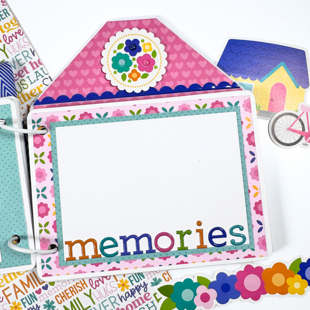 House Shaped Family Scrapbook Album Page with flowers, a photo mat, and puffy stickers that say memories