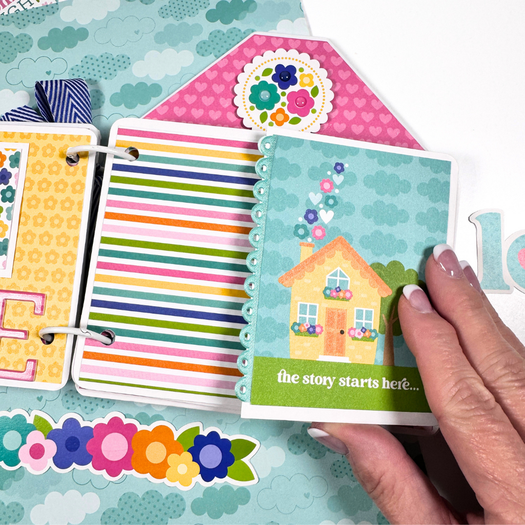 House Shaped Family Scrapbook Album Page with a fold-out section, colorful stripes, hearts, flowers, and a pretty scalloped ribbon