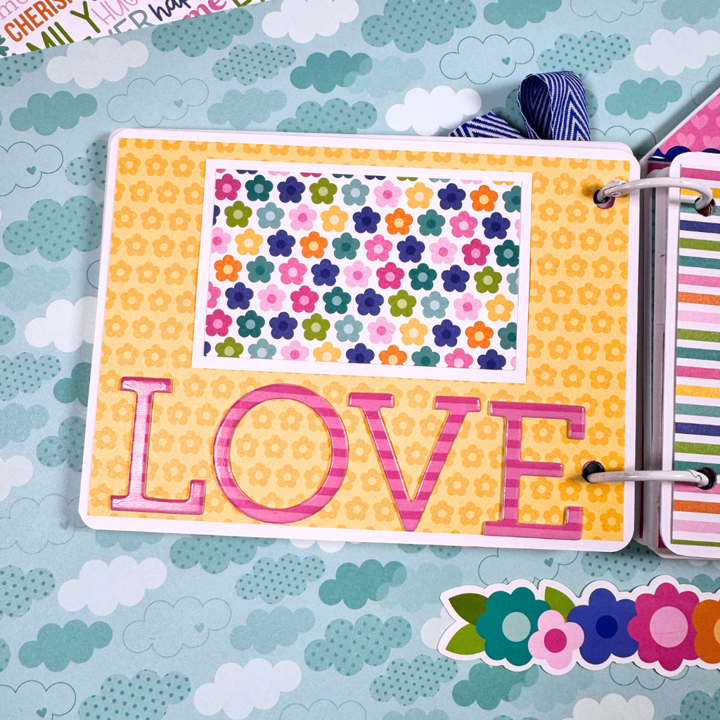 Family Scrapbook Mini Album Page with colorful flowers and chipboard letters that spell love
