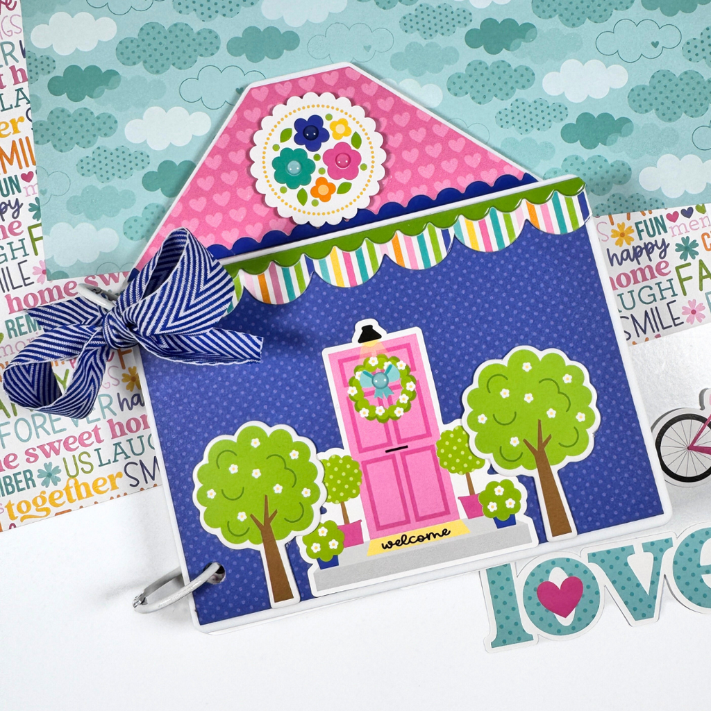House Shaped Family Scrapbook Mini Album with a pink door, flowers, hearts, a bow, and cute trees