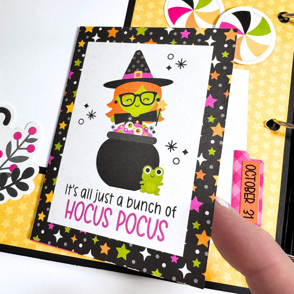 Halloween Scrapbook Album Page with a folding card, a cute witch, a cauldron, a tiny frog, and stars