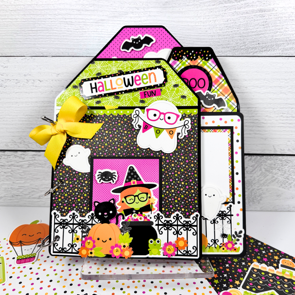 Halloween Fun House Shaped Scrapbook Album sitting on a clear acrylic display stand