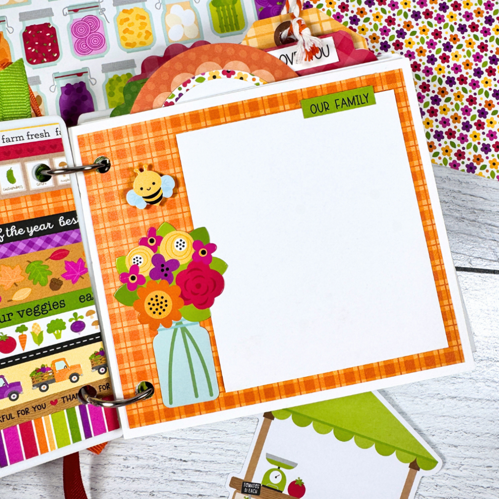 Our Family Memories Fall Scrapbook Album Page with a jar, colorful flowers, a cute bee, and an orange plaid paper