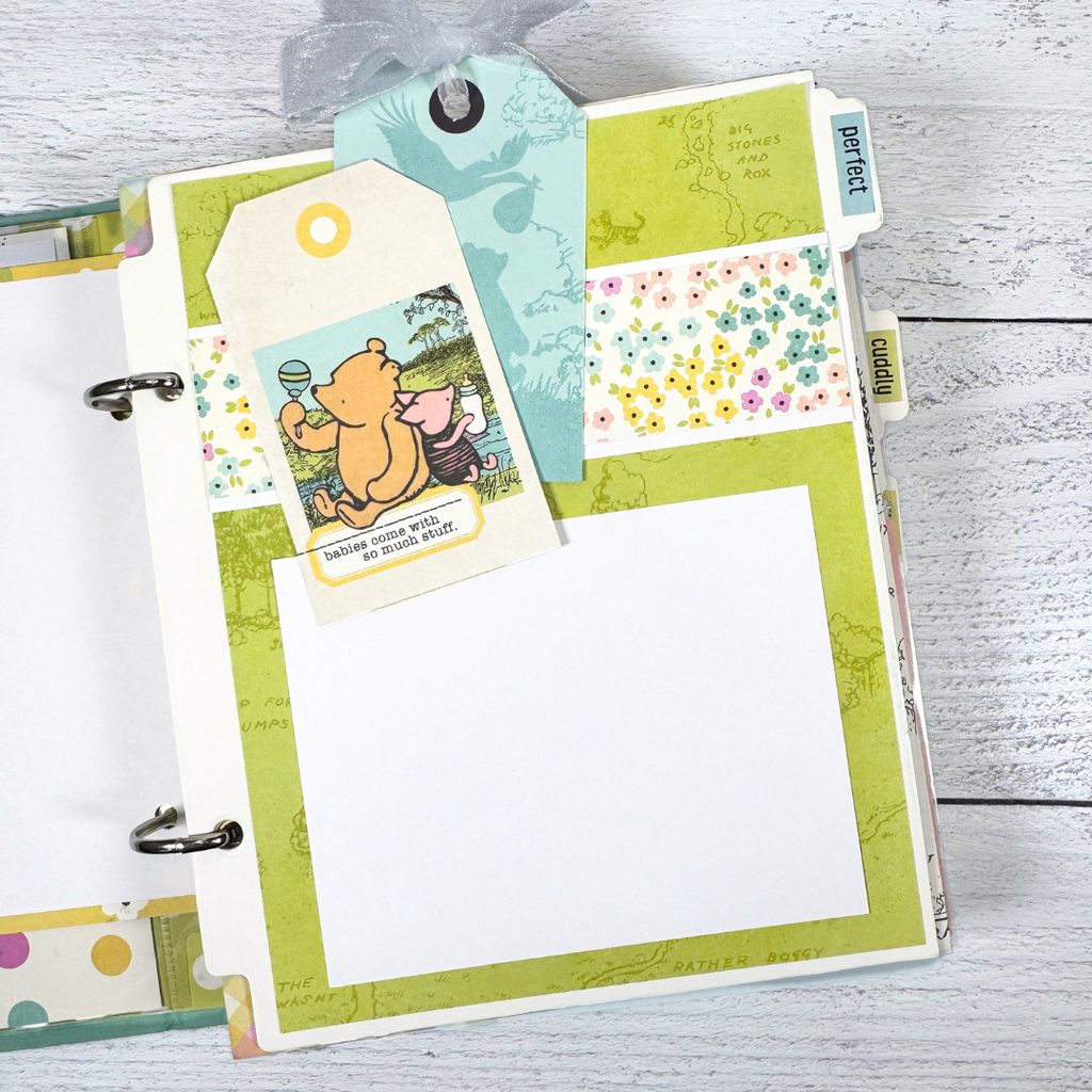 Winnie the Pooh Baby Scrapbook Album Page with cute tags, Piglet, a stork, and flowers