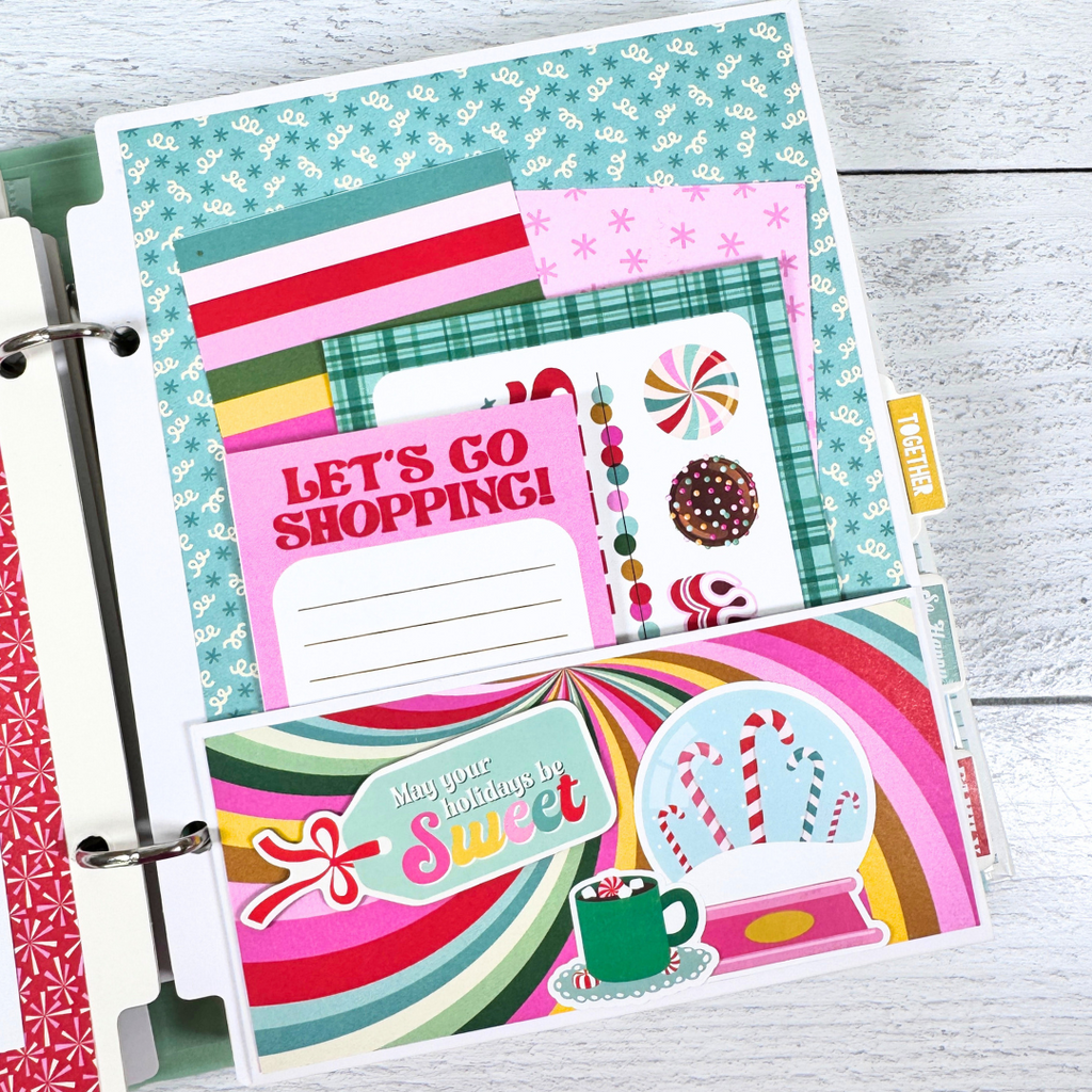 Christmas 25 Scrapbook Mini Album Page with a snow globe, candy canes, hot cocoa, a pocket, and journaling cards