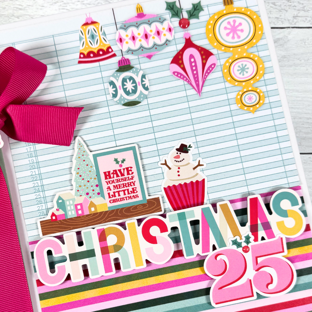 Christmas 25 Scrapbook Mini Album with pretty ornaments, a snowman cupcake, colorful stripes, and a big pink bow