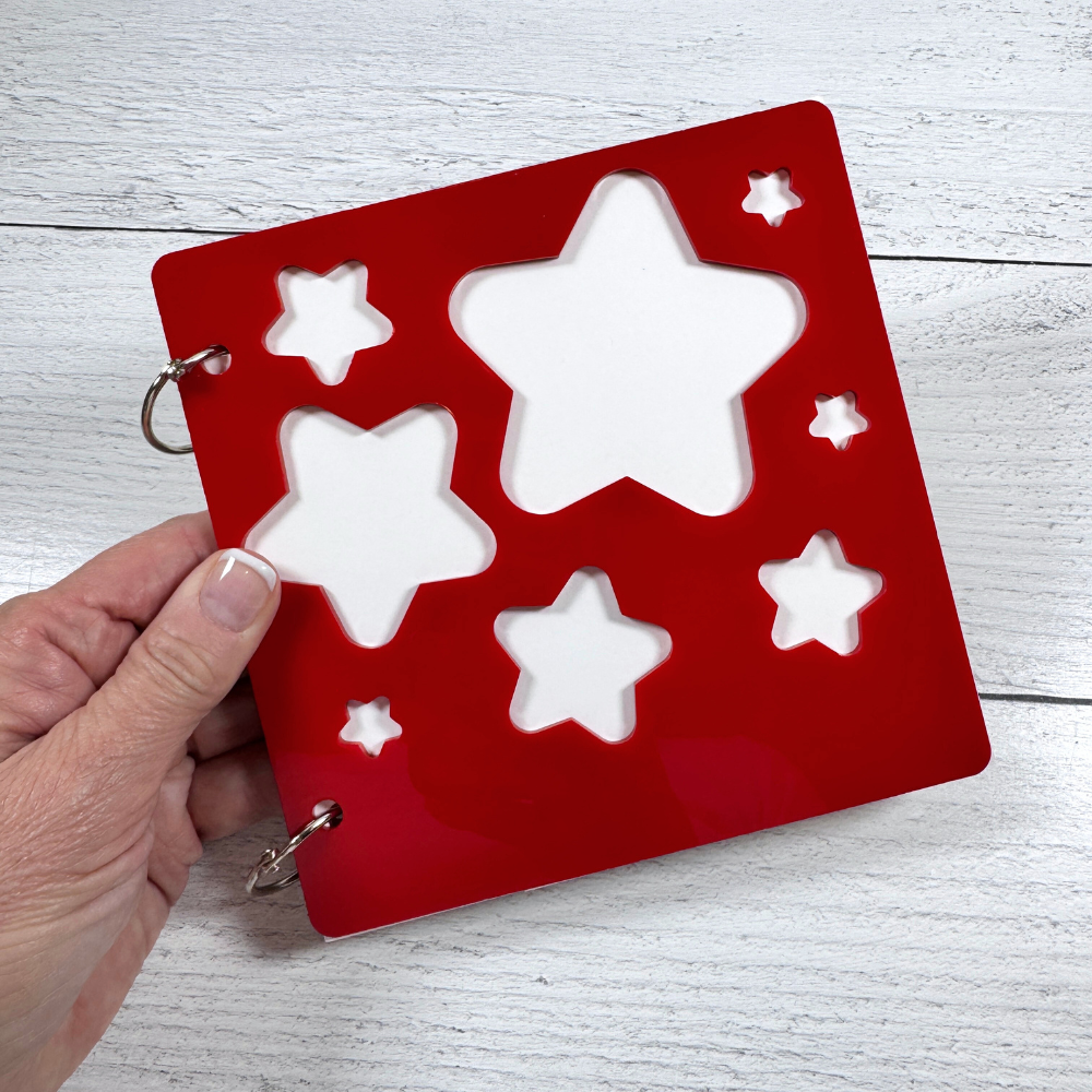 Acrylic Peek-A-Boo Stars Mini Album with star shaped cut-outs, white card stock pages, and binding rings