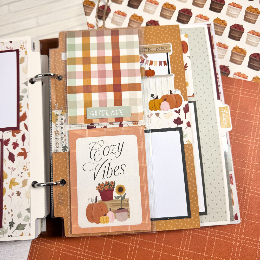 Gather Together Fall Scrapbook Album Page with autumn colors, falling leaves, flowers, pumpkins, and a clear divided pocket page