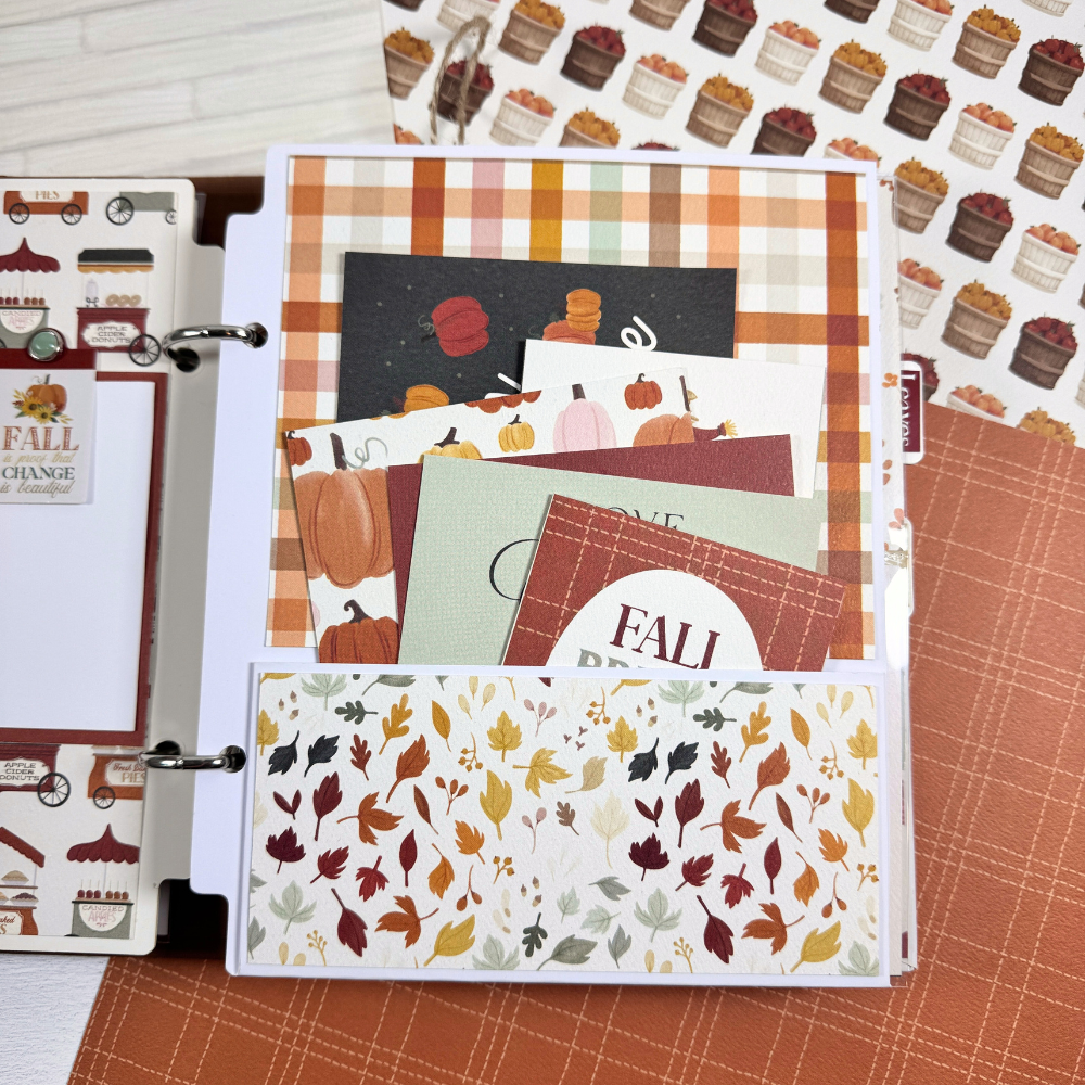 Gather Together Fall Scrapbook Album Page with a pocket, colorful leaves, a pretty plaid paper, and journaling cards