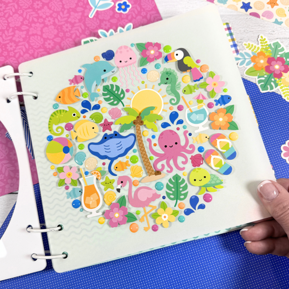Adventure Awaits Summer Fun Scrapbook Album Page with lots of stickers of seashells, beach items, flowers, sun, palm tree, and cute sea creatures