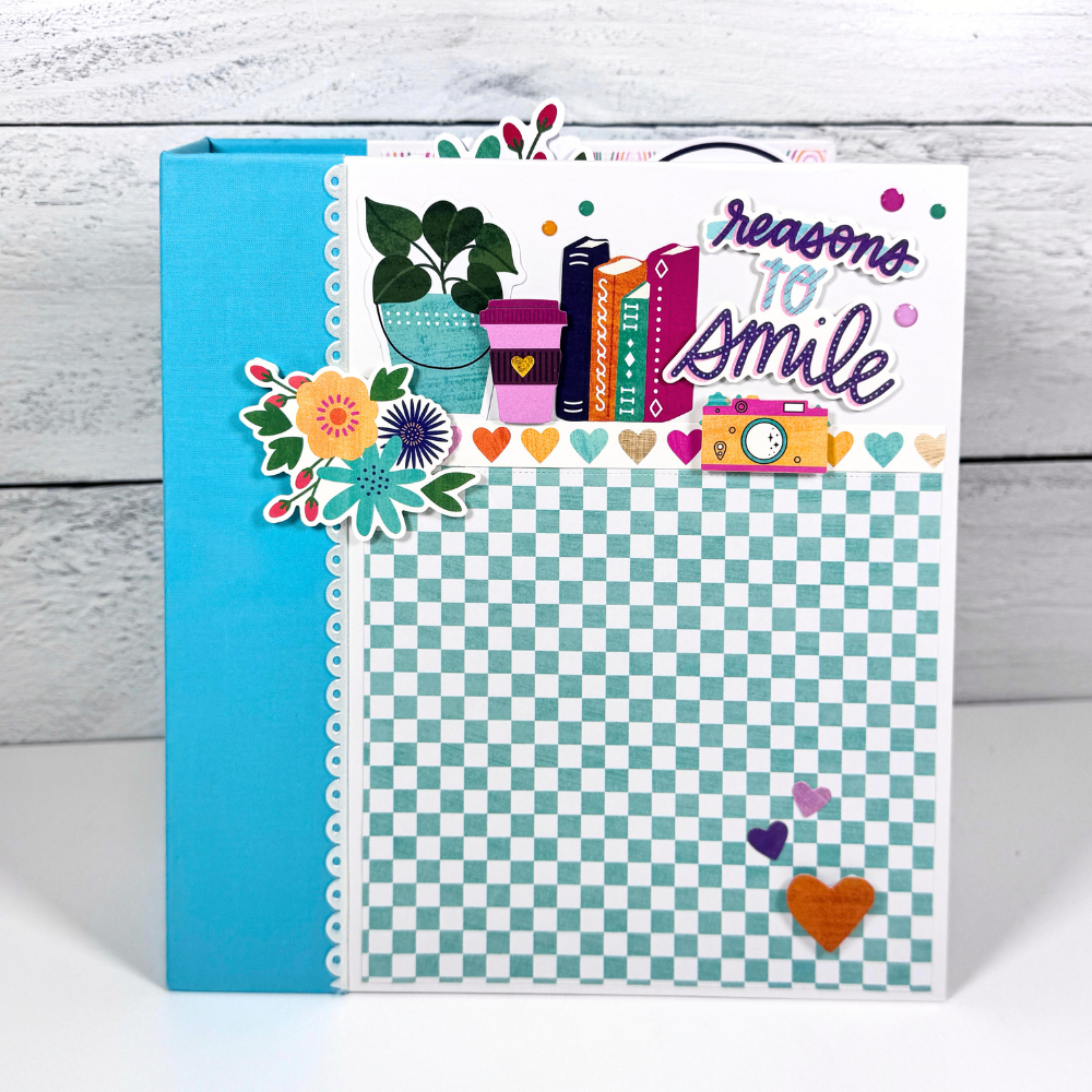 Reasons To Smile Scrapbook Album with flowers, hearts, books, cameras, potted plants, and rainbows