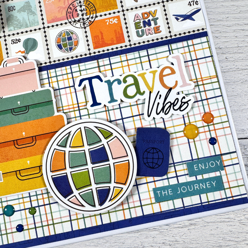 Travel Vibes Scrapbook Mini Album with airplanes, maps, luggage, hot air balloons, and globes