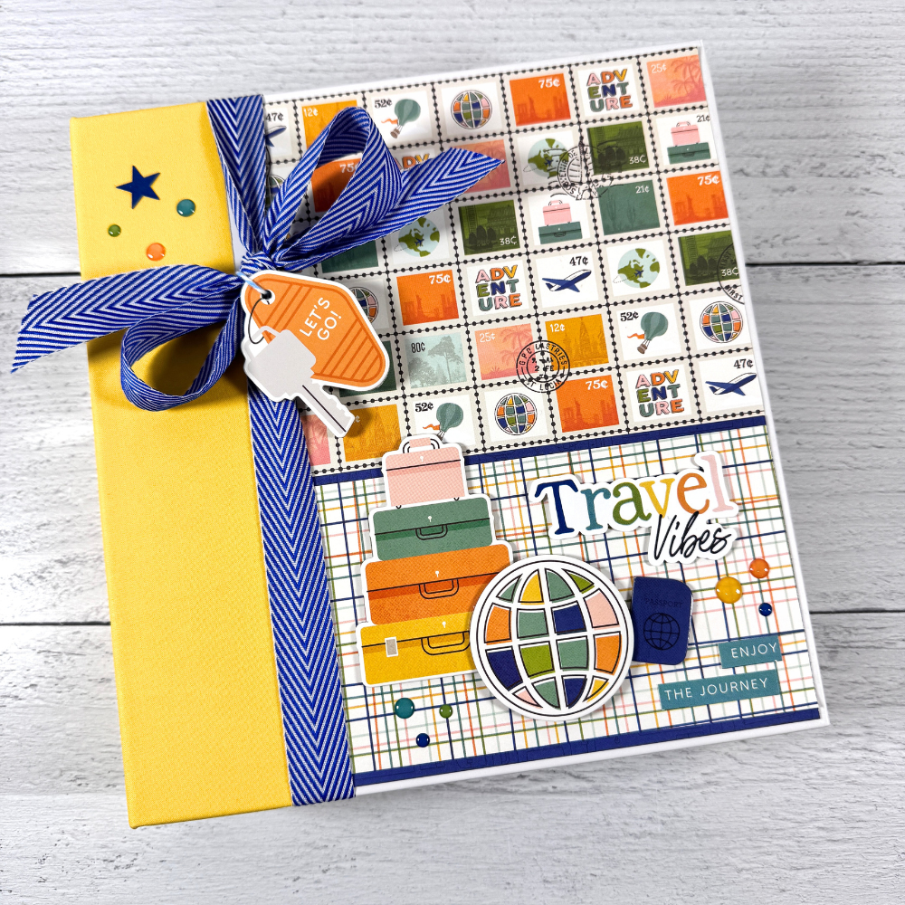 Travel Vibes Scrapbook Mini Album with airplanes, maps, luggage, hot air balloons, and globes