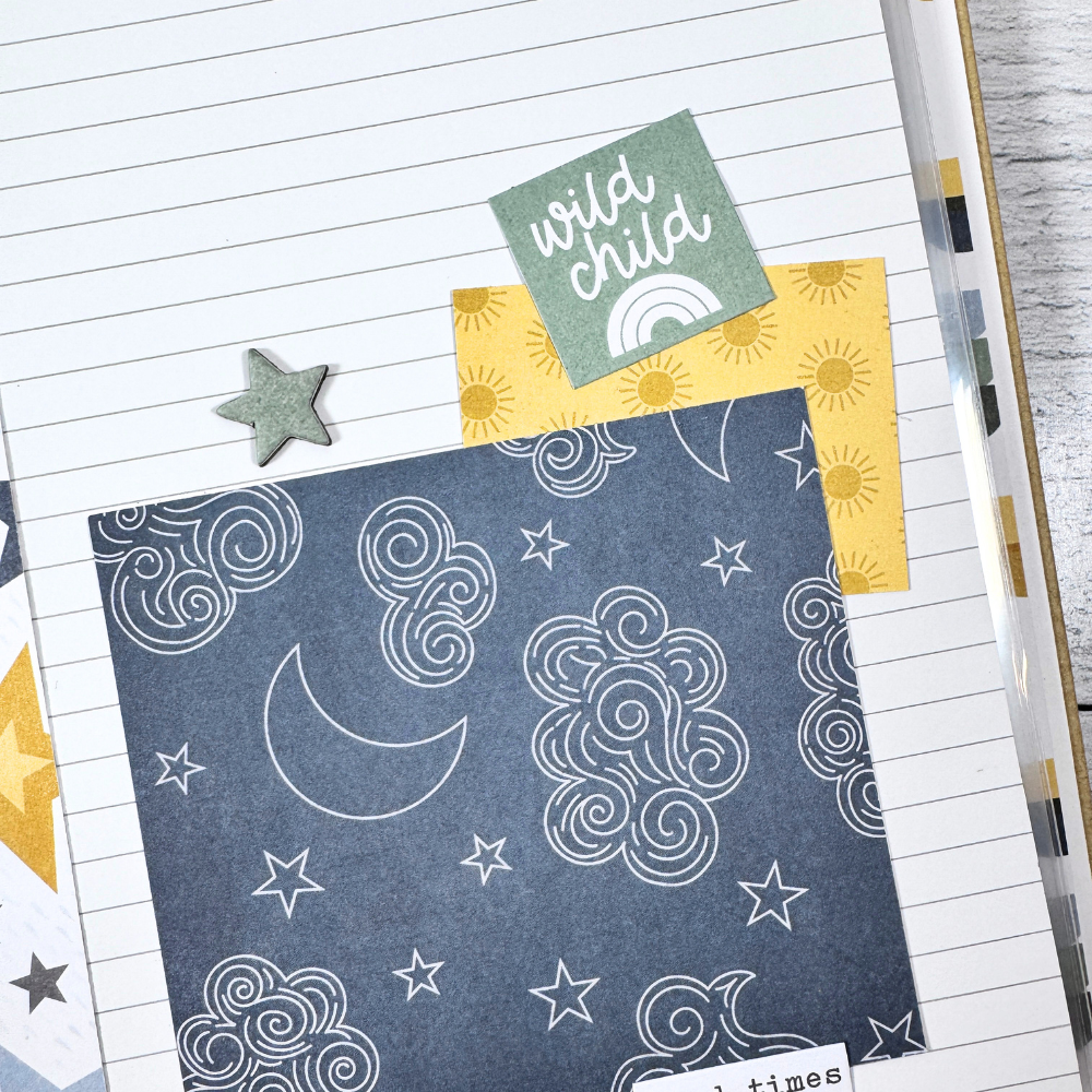 Say Hello To New Adventure Mini Scrapbook Page with the sun, stars, clouds, a moon, and lines for journaling