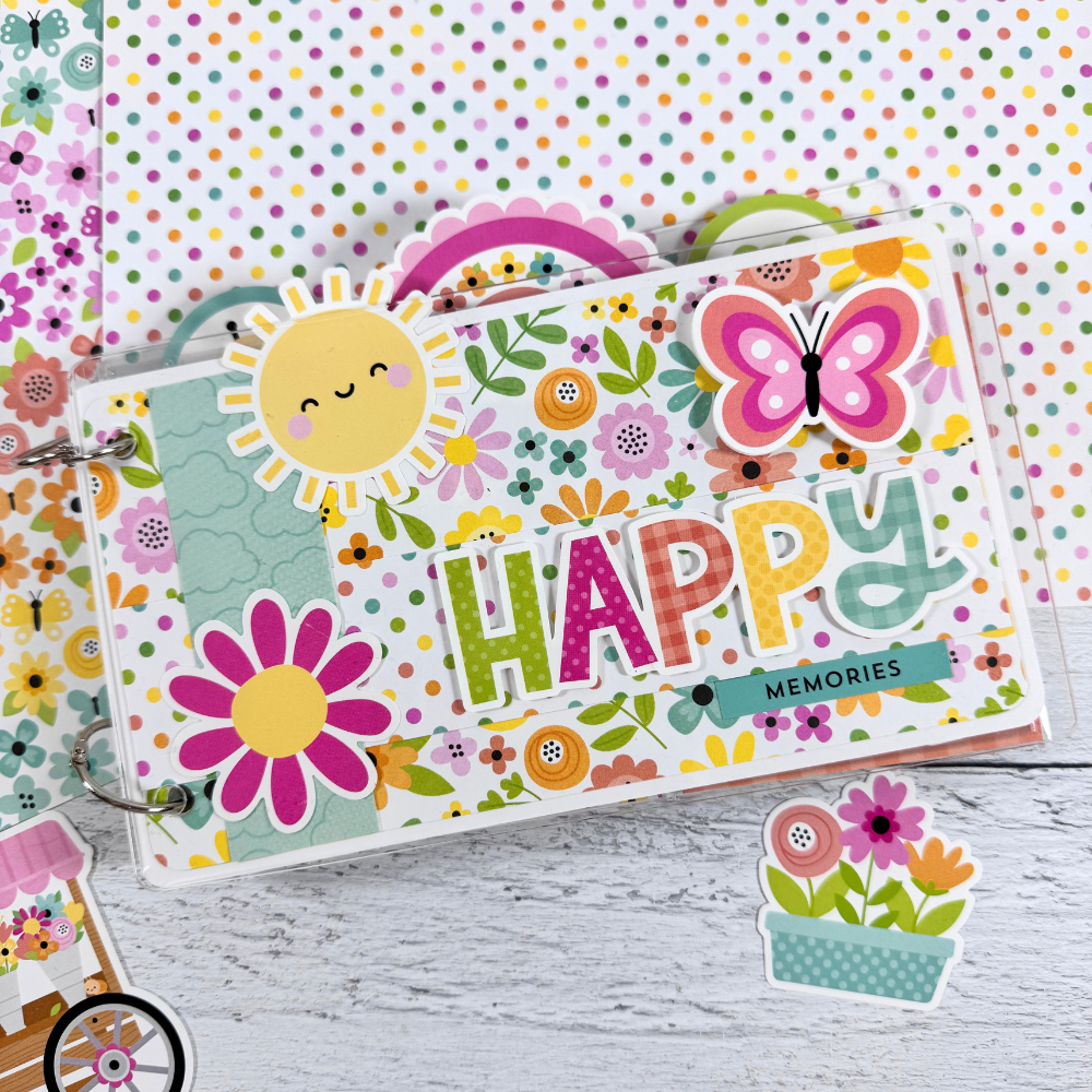 Happy Memories Scrapbook Mini Album with spring flowers, butterflies, sunshine, and colorful polka dots