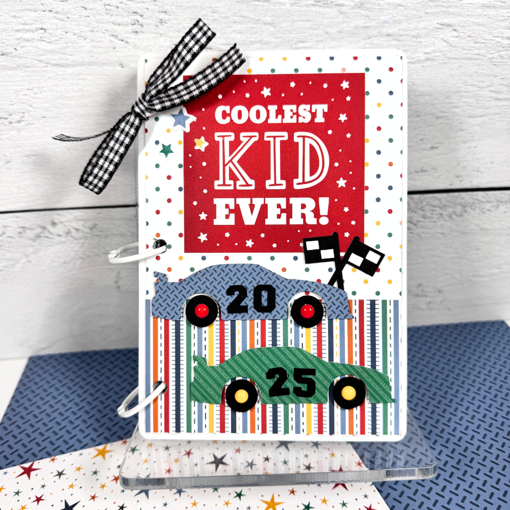 Coolest Kid Ever Scrapbook Mini Album with race cars, stars, flags, and a clear acrylic display stand