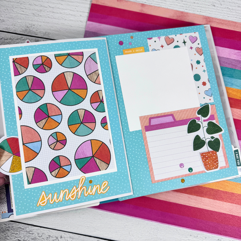 Reasons To Smile Scrapbook Album Page with a colorful circle pattern, hearts, potted plants, and enamel dots