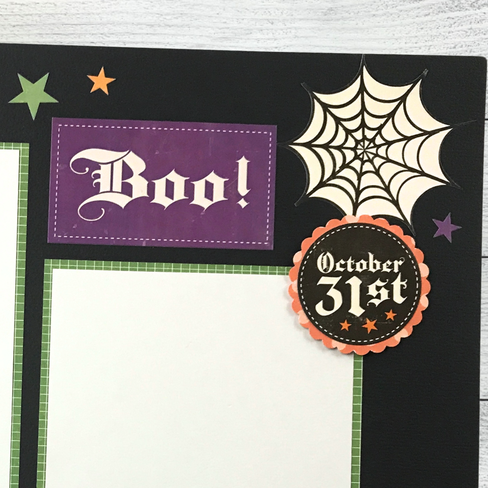 12x12 Spooktacular Halloween Scrapbook Layout with stars, a spider web, and a scalloped circle 