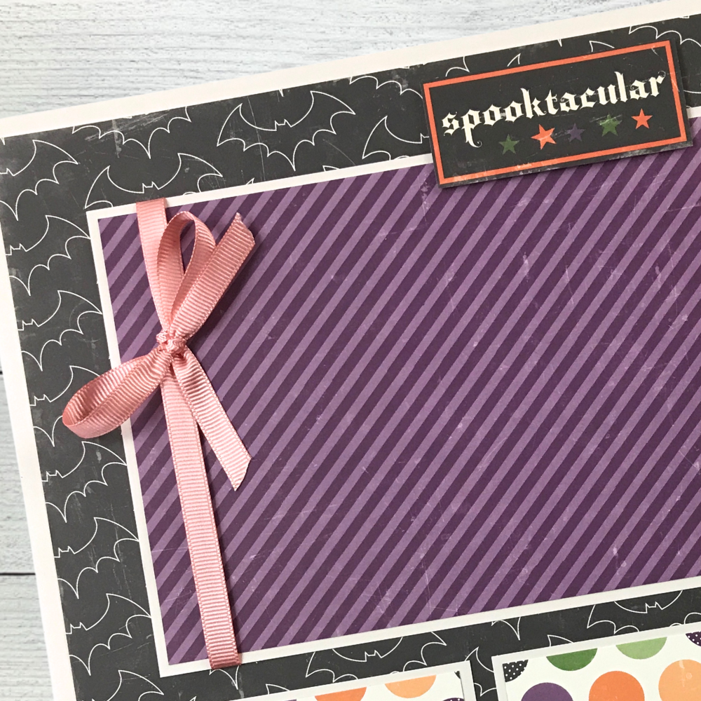 12x12 Spooktacular Halloween Scrapbook Layout with bats, stars, polka dots, and a ribbon with a bow