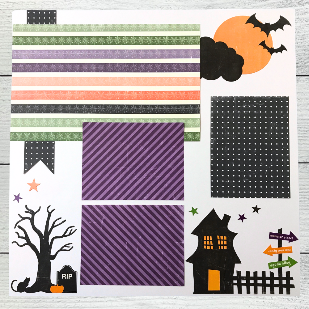 12x12 Spooktacular Halloween Scrapbook Layout with bats, a haunted house, a tree, cat, pumpkin, and stars