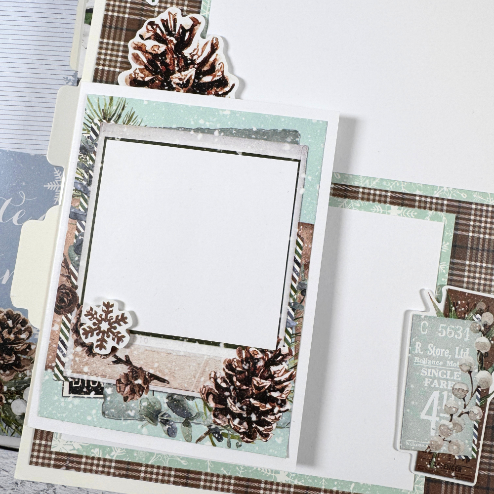 Chasing Snowflakes Winter Scrapbook Album Page with a folding card, pinecones, and snow