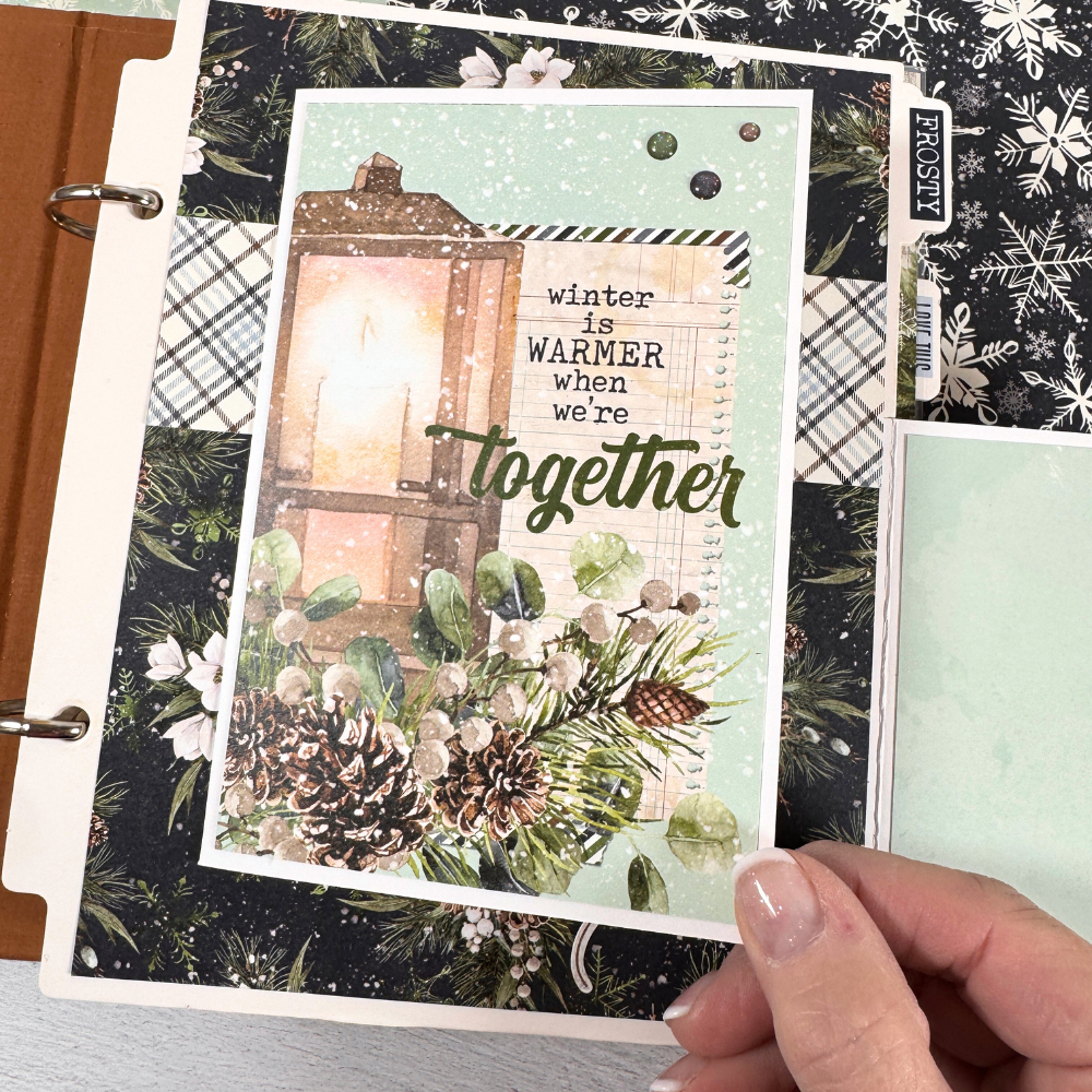 Chasing Snowflakes Winter Scrapbook Album Page with a folding card, flowers, pinecones, and a lantern