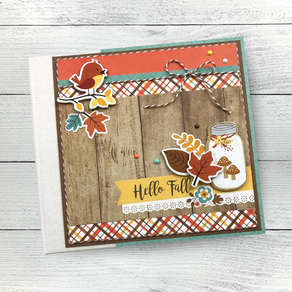 Hello Fall Perfect Autumn Scrapbook Album with a bird, leaves, a jar, mushrooms, and a bow