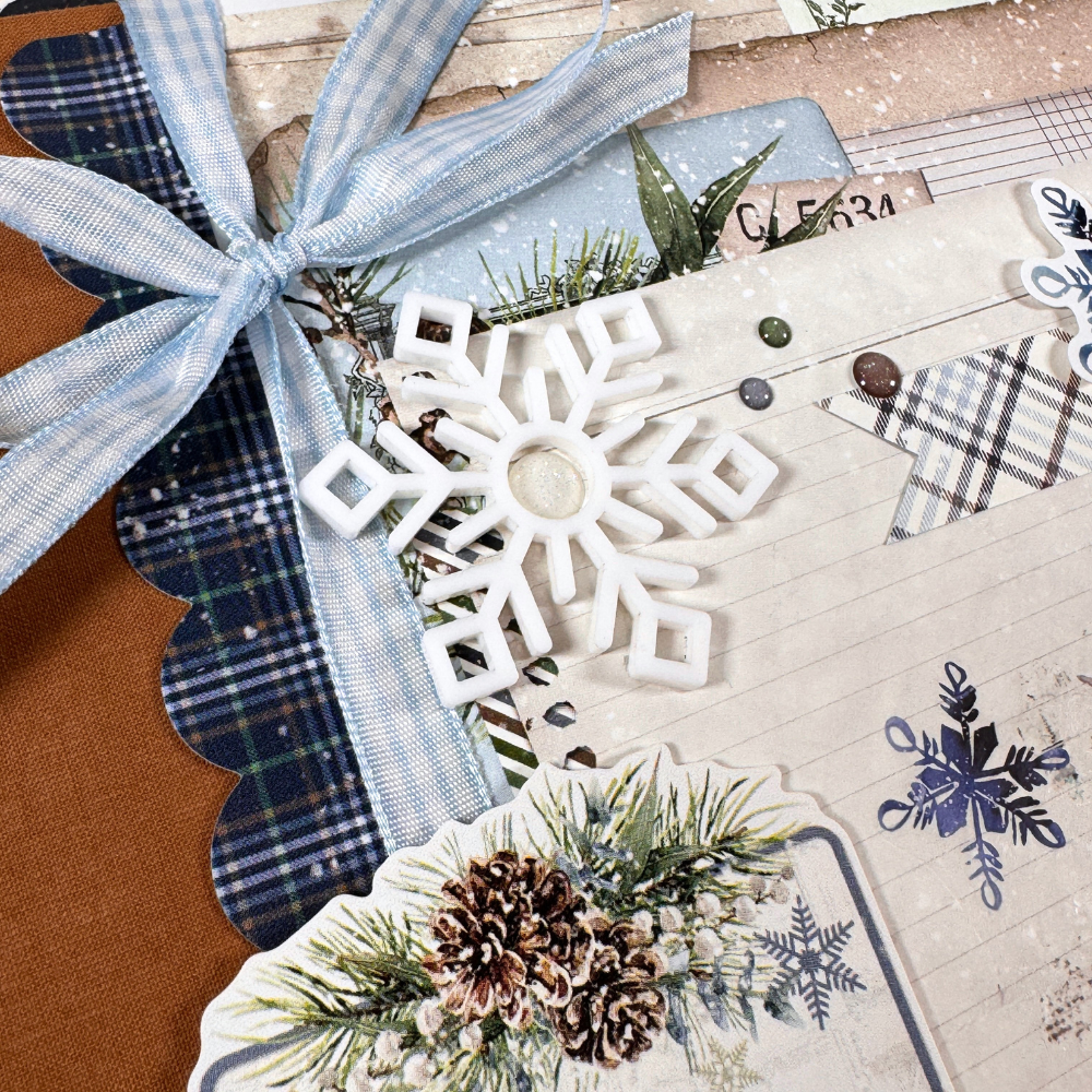 Chasing Snowflakes Winter Scrapbook Album with a gingham bow, snowflakes, and pinecones