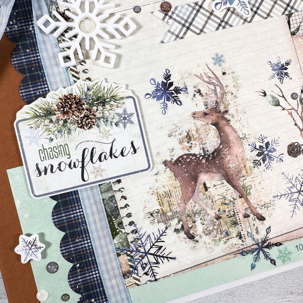 Chasing Snowflakes Winter Scrapbook Album with a deer, pinecones, snowflakes, and enamel dots