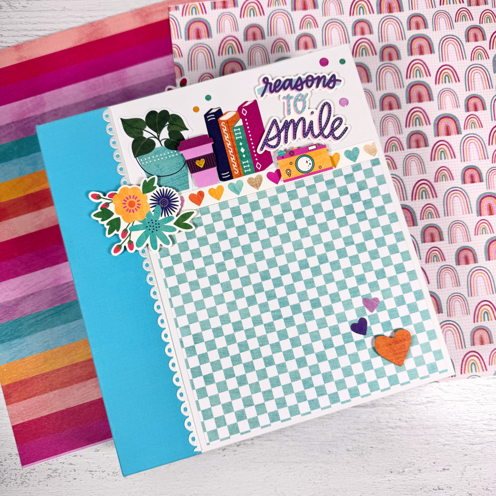 Reasons To Smile Scrapbook Album with flowers, hearts, books, cameras, potted plants, and rainbows