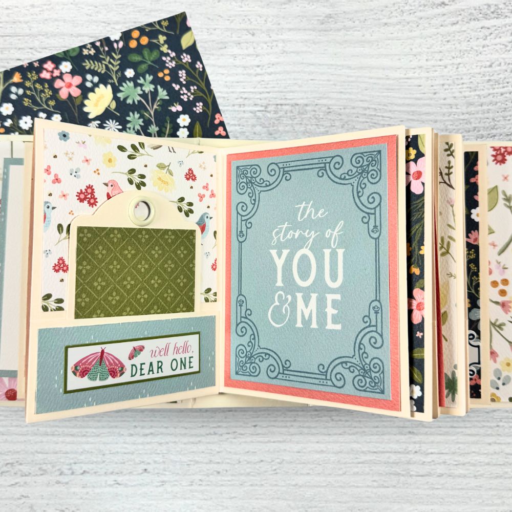 Always Forever Scrapbook Mini Album Page with a pocket, a tag with a grommet, flowers, butterflies, and birds