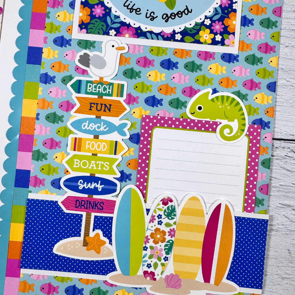 12x12 Living the Dream Summer Scrapbook Page Layout with colorful fish, flowers, surfboards, a seagull, and a cute chameleon