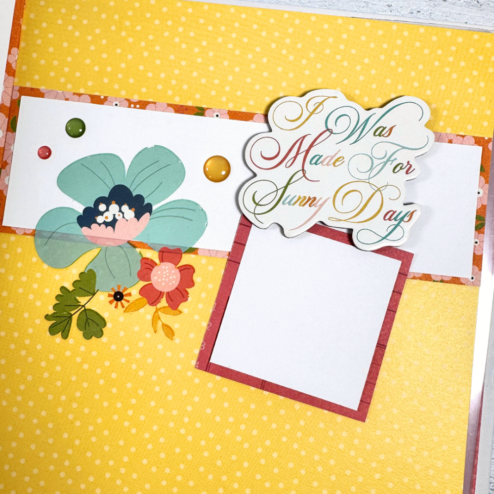 Sunny Days Summer Scrapbook Album Page with pretty rub-on flowers, yellow polka dots, and enamel glitter dots