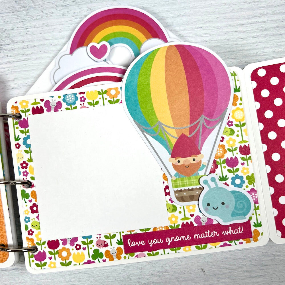 Spring Scrapbook Album Page with a hot air balloon, a gnome, flowers, rainbows, ladybugs, butterflies