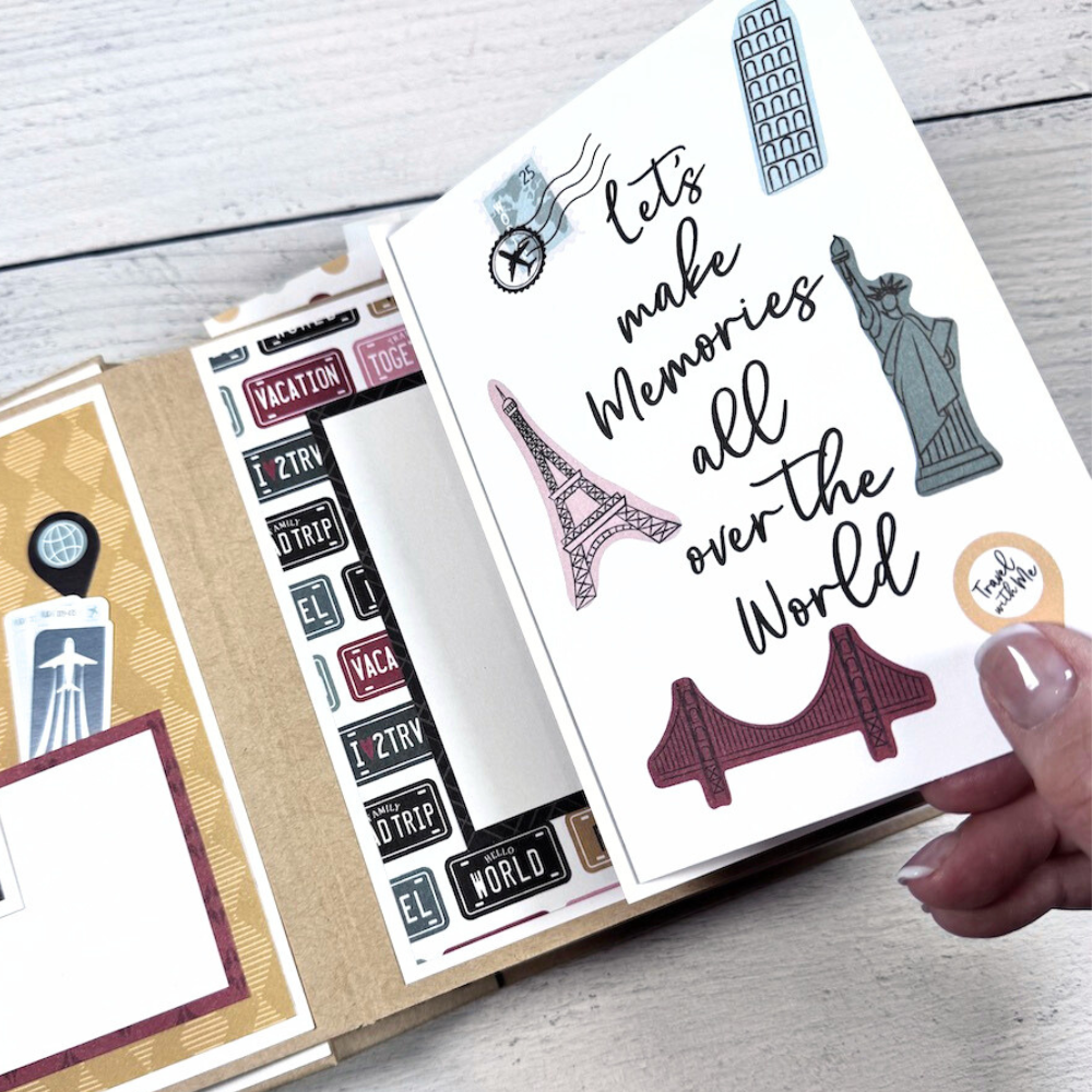 Travel The World With Me Scrapbook Album page with the statue of liberty, the Eiffel tower, leaning tower of Pisa, and travel stamps