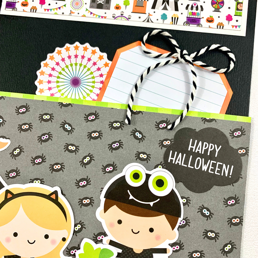 12x12 Halloween Memories Scrapbook Page Layout with carnival rides, fireworks, spiders, a tag shaped journaling card, and a twine bow  