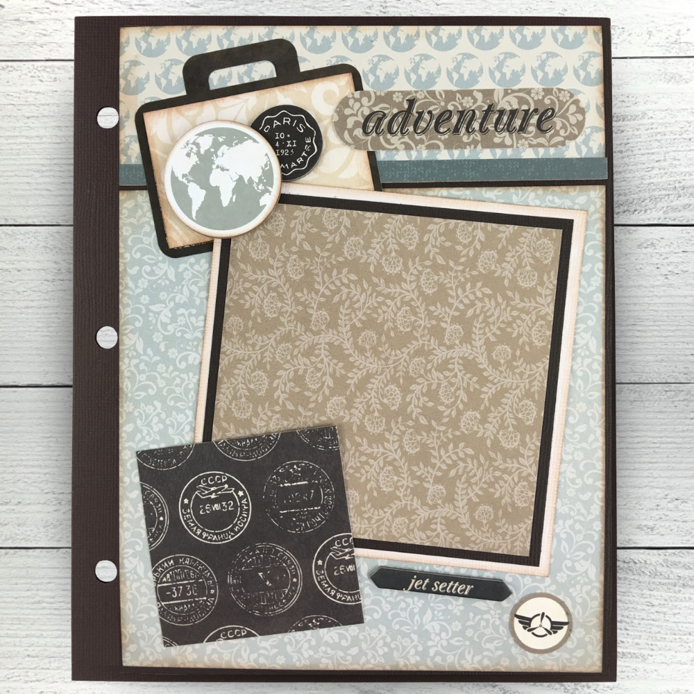 Vintage Travel Scrapbook Album page with globes, a suitcase, travel stamps a  floral pattern, and a photo mat 